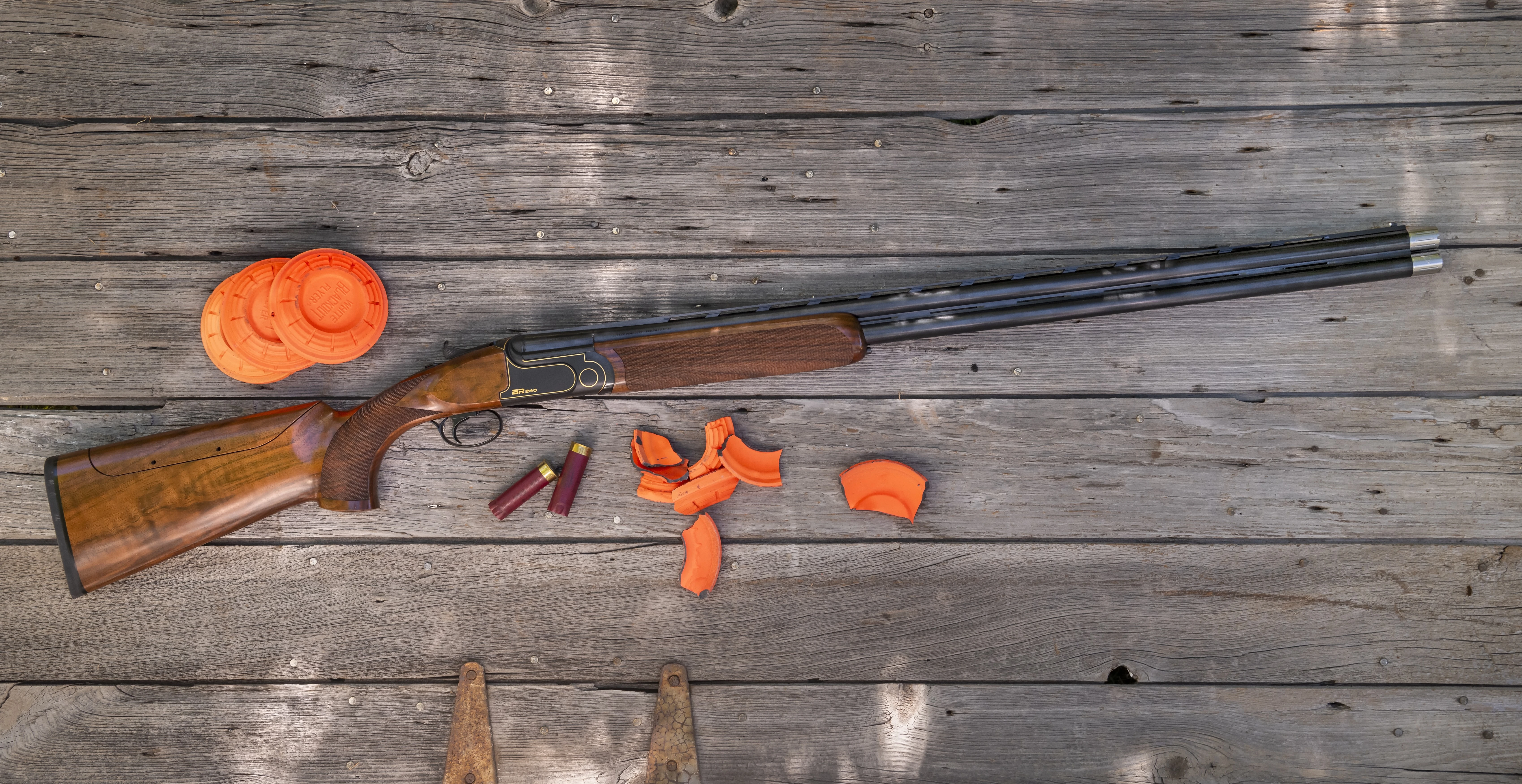 The new Rizzini BR 240 Cole Special Sporting lying on a wood surface with clay birds. 