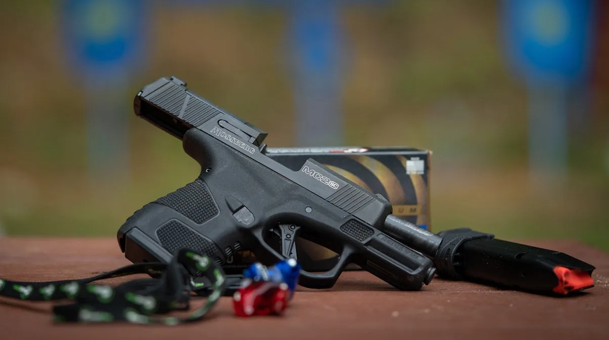 The Mossberg MC2sc handgun on a bench with the slide open.