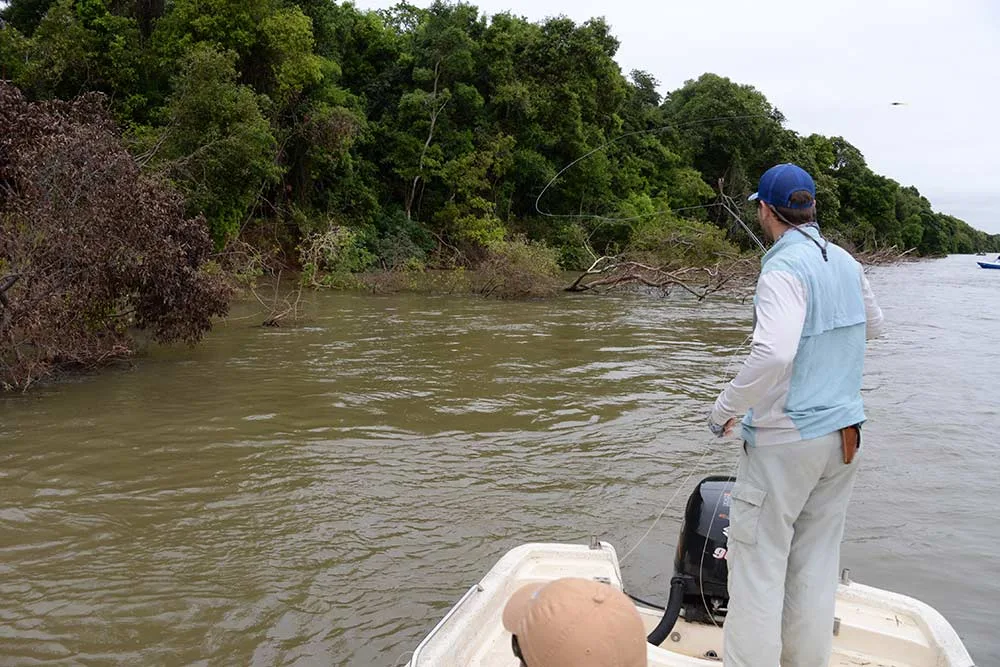 fisherman casting line into the water of the parana river