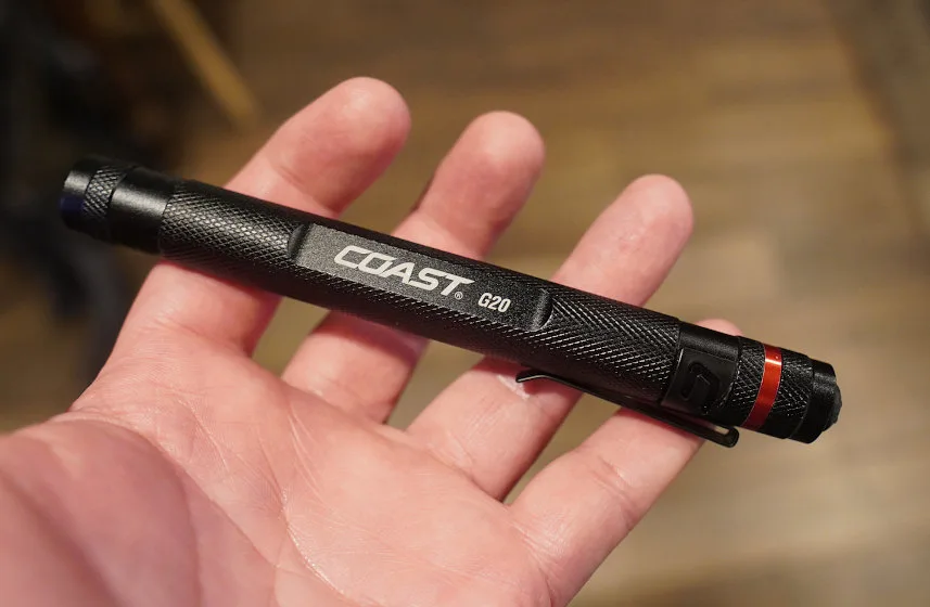 Close-up of man's hand holding Coast G20 flashlight