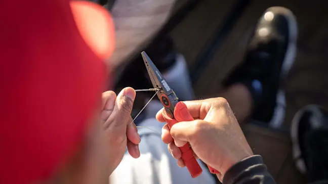 angler using fishing pliers