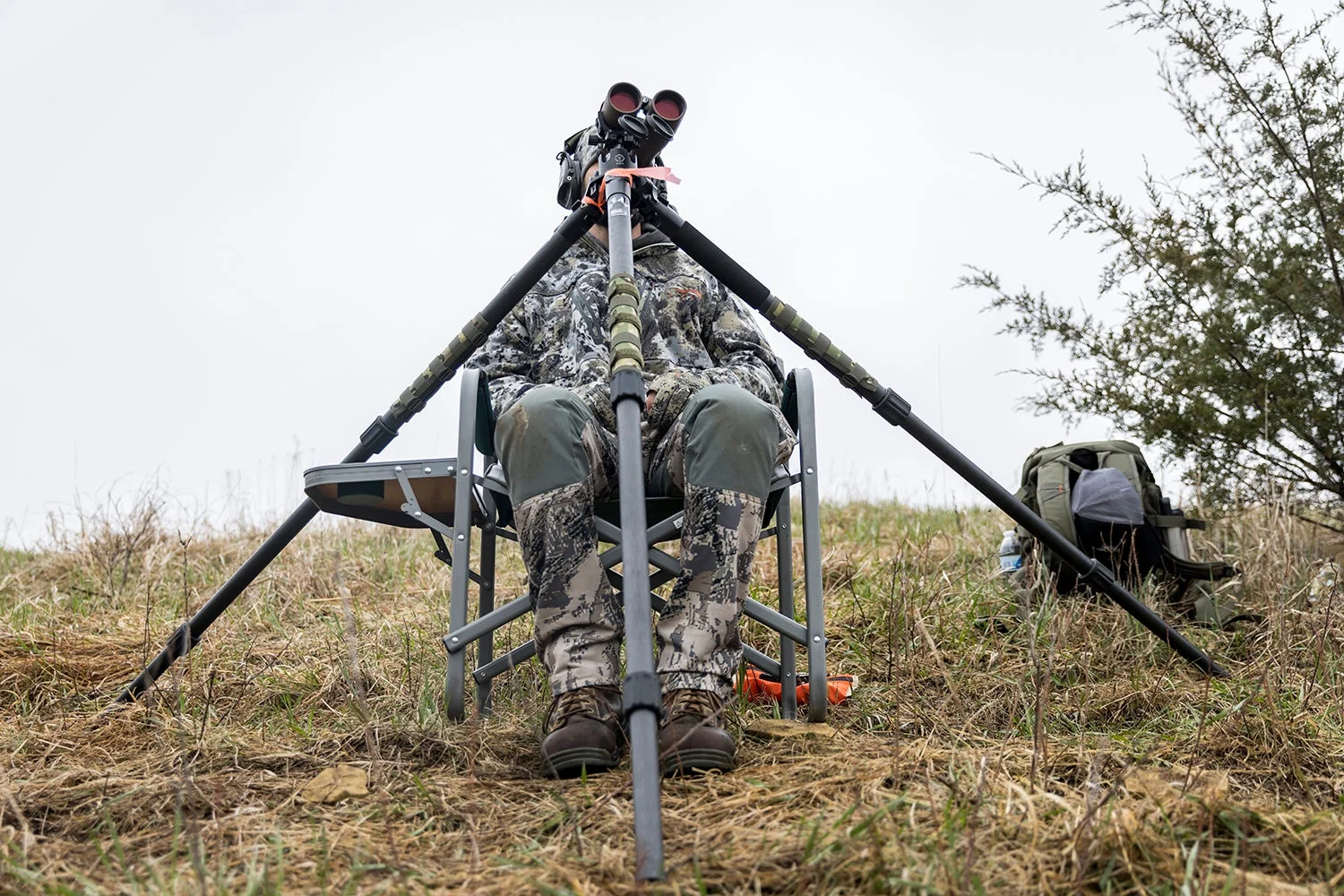 Range officer peers through binoculars