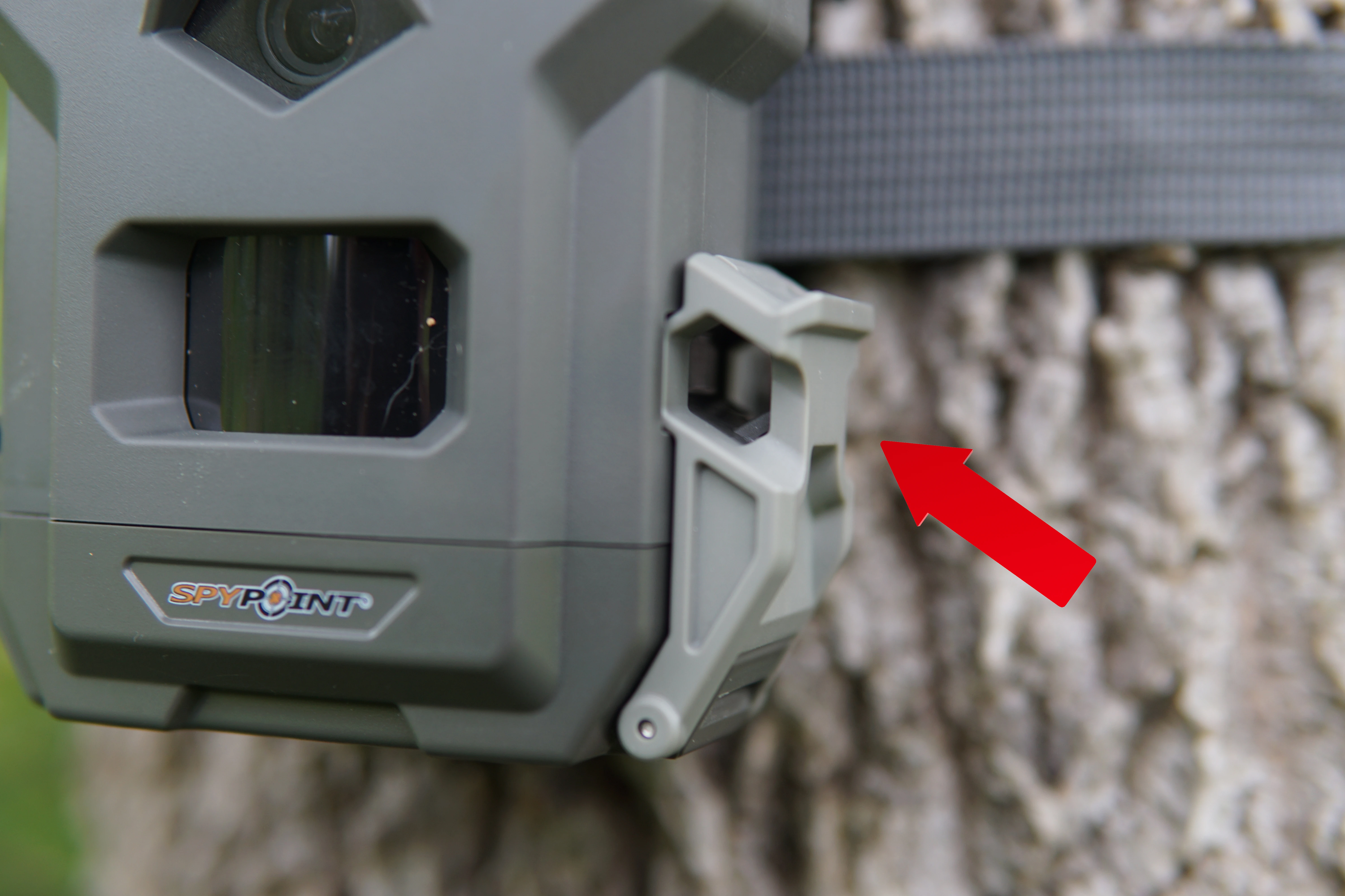 Closeup of the cable-lock slot on the door latch of Spypoint Flex-M trail camera. 