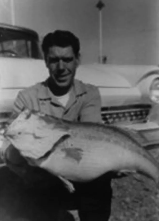 An angler poses with the Missouri state record for largemouth bass. 