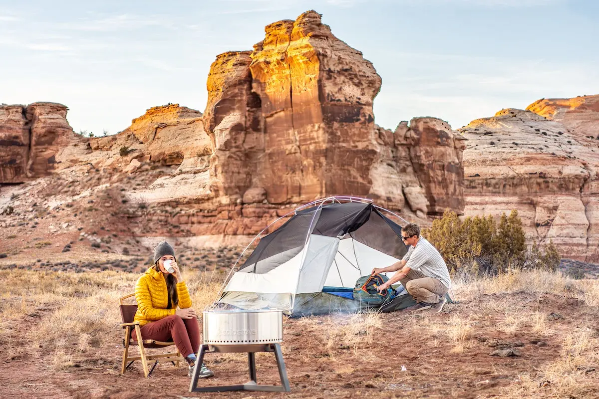 Campers using Solo Stove Bonfire fire pit in desert