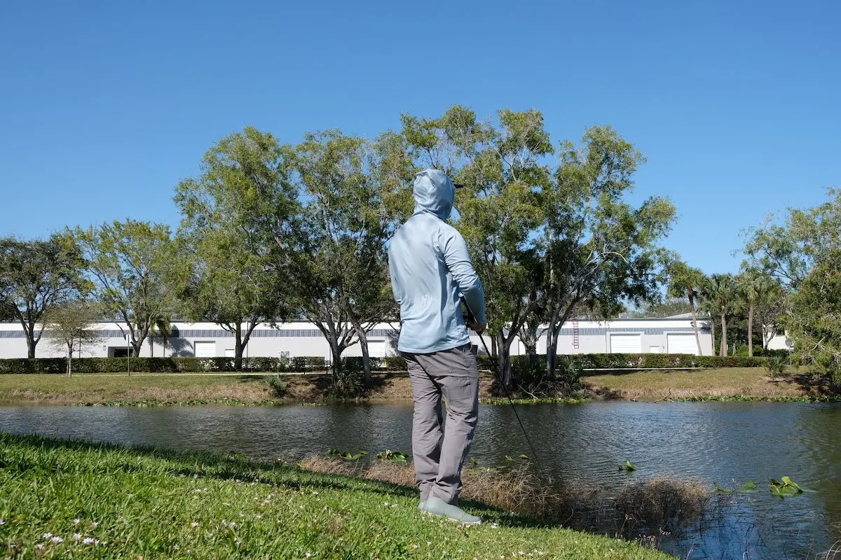 Angler fishing from the shore wearing Mountain Khakis fishing pants