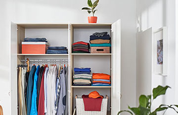 large closet full of clothes with door wide open