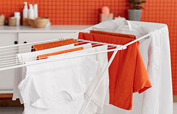 drying rack with clean clothes hanging on it
