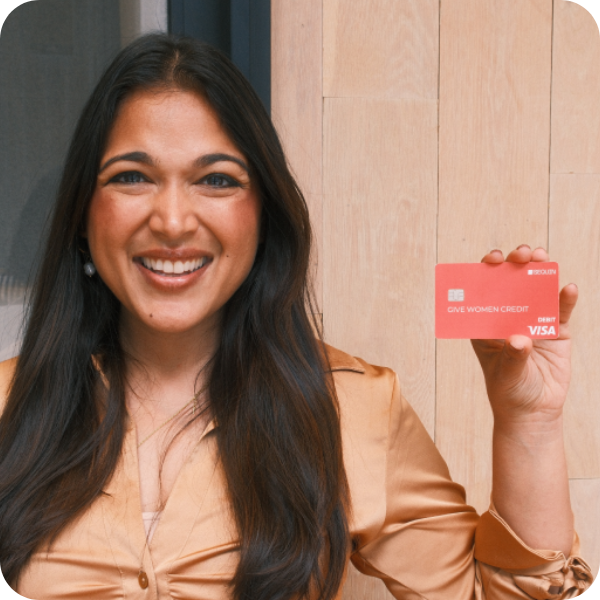 Sequin CEO and Co-Founder, Vrinda Gupta, holding Sequin Rewards Visa® Debit Card that reads "GIVE WOMEN CREDIT"