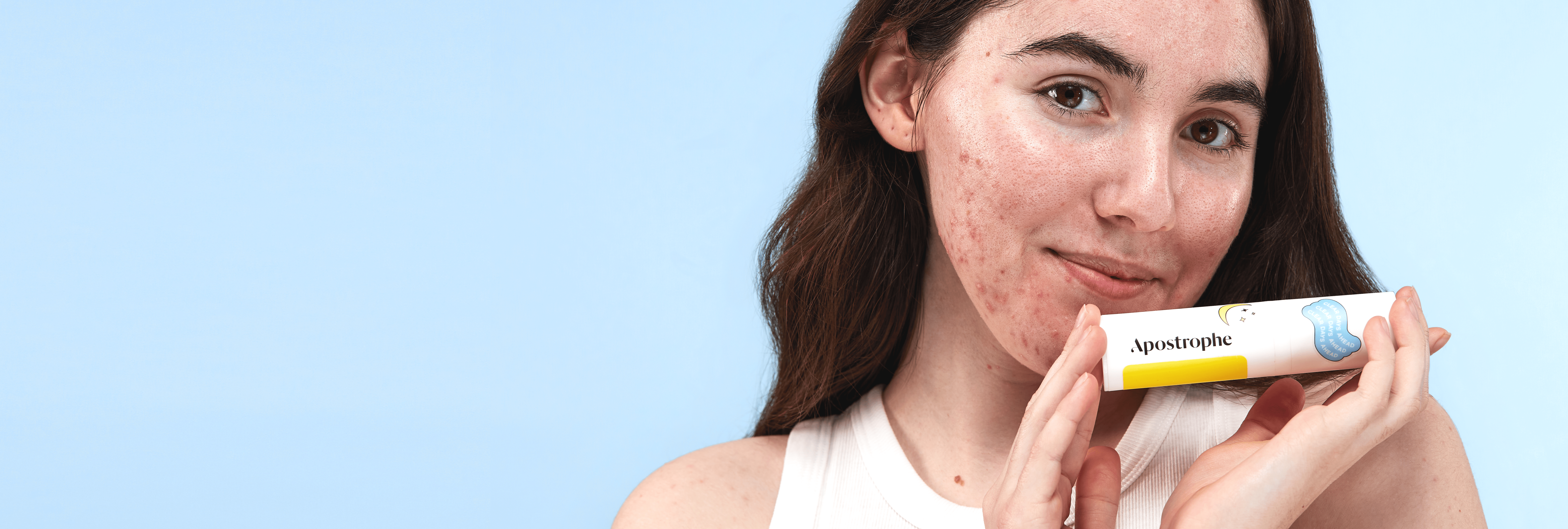 woman holding a bottle of topical medication