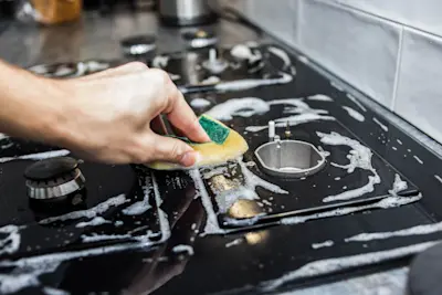 how to get black stuff off stove top