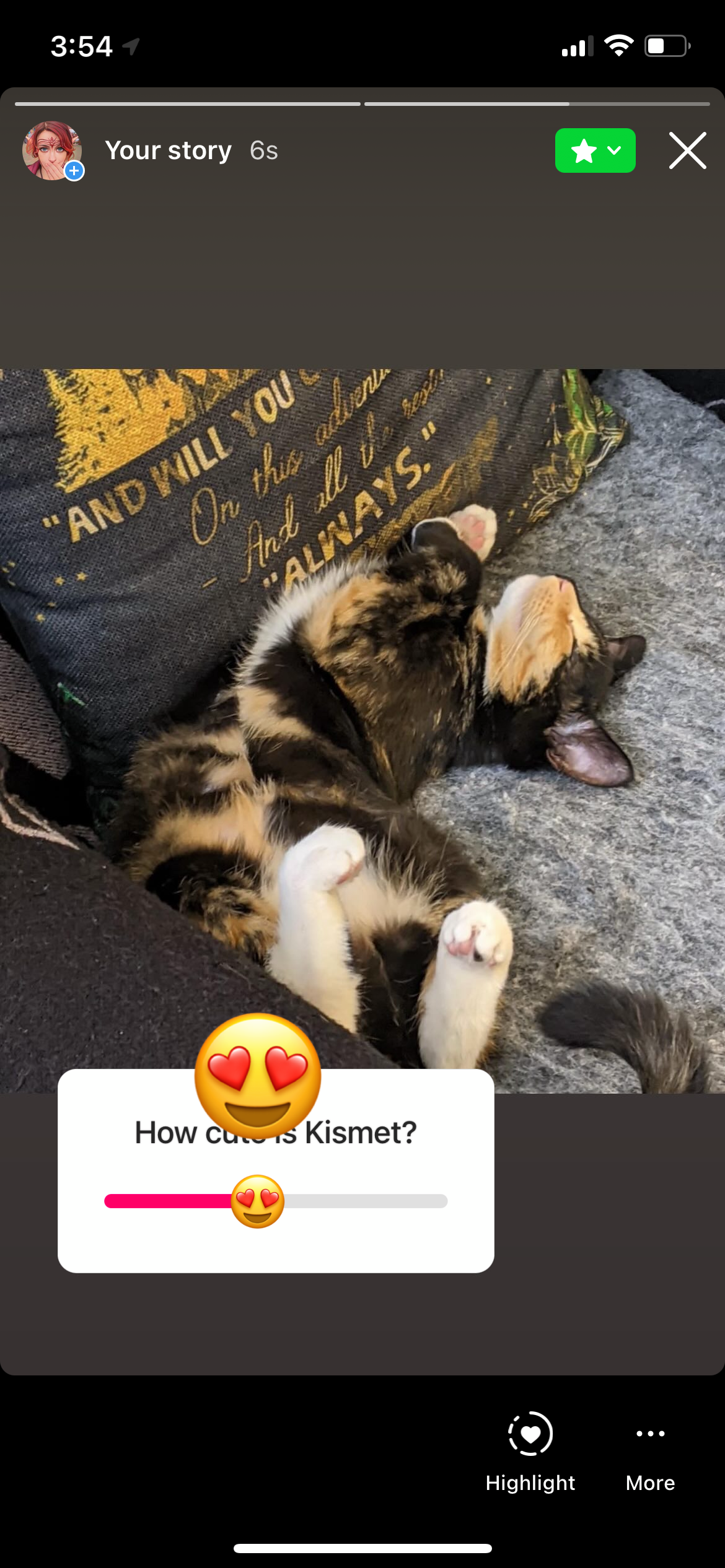 A screengrab of the mobile view of Instagrams Stories, showing a calico kitten sleeping in a silly position, belly up, on a chair. There is an overlay of a slider box with the label How cute is Kismet?. The selection thumb is the heart eyes emoji.