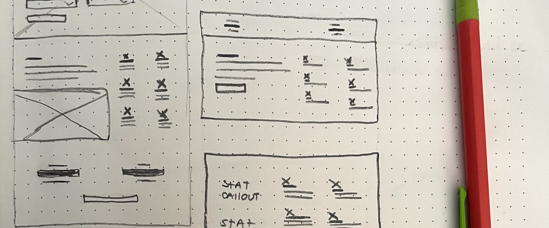 A notebook with many rough sketches for a wireframe.