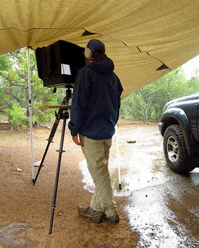 Standing at my standing desk under a tent shelter in the rain