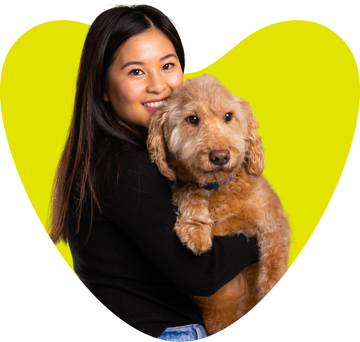 A woman with her dog in a heart shape