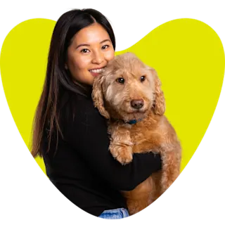 A woman with her dog in a heart shape