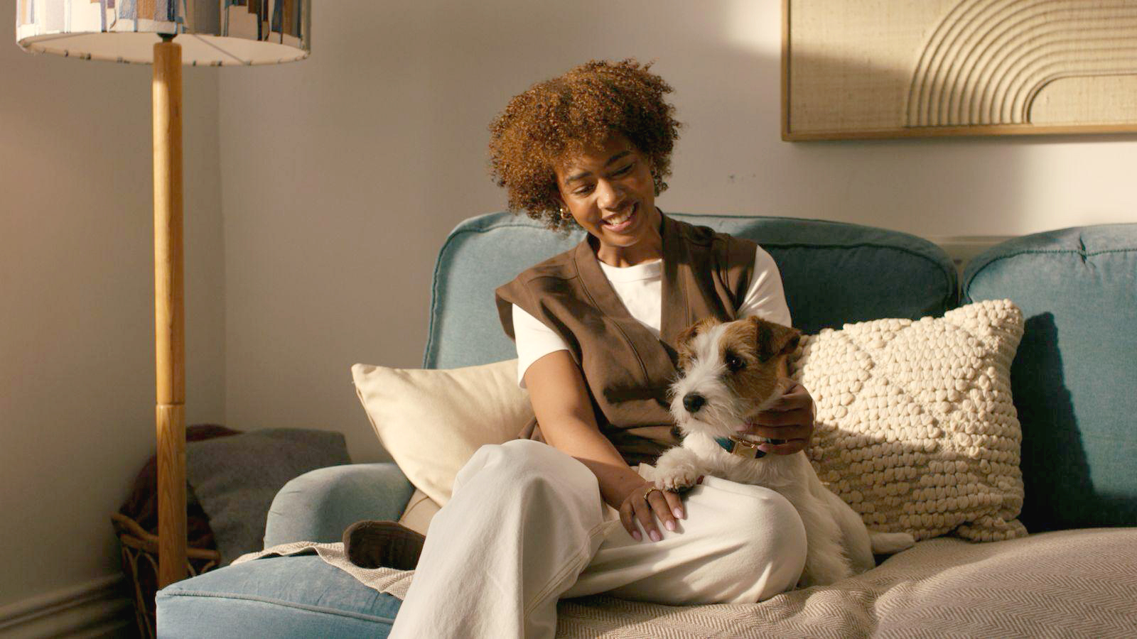 Woman on couch with jack russel dog