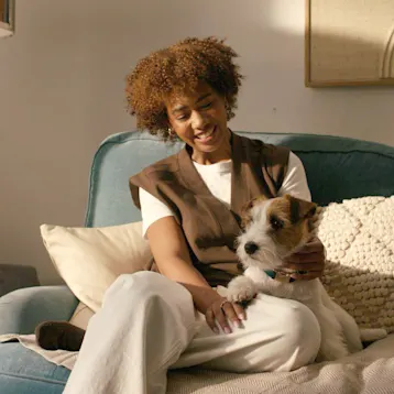 Woman on couch with jack russel dog