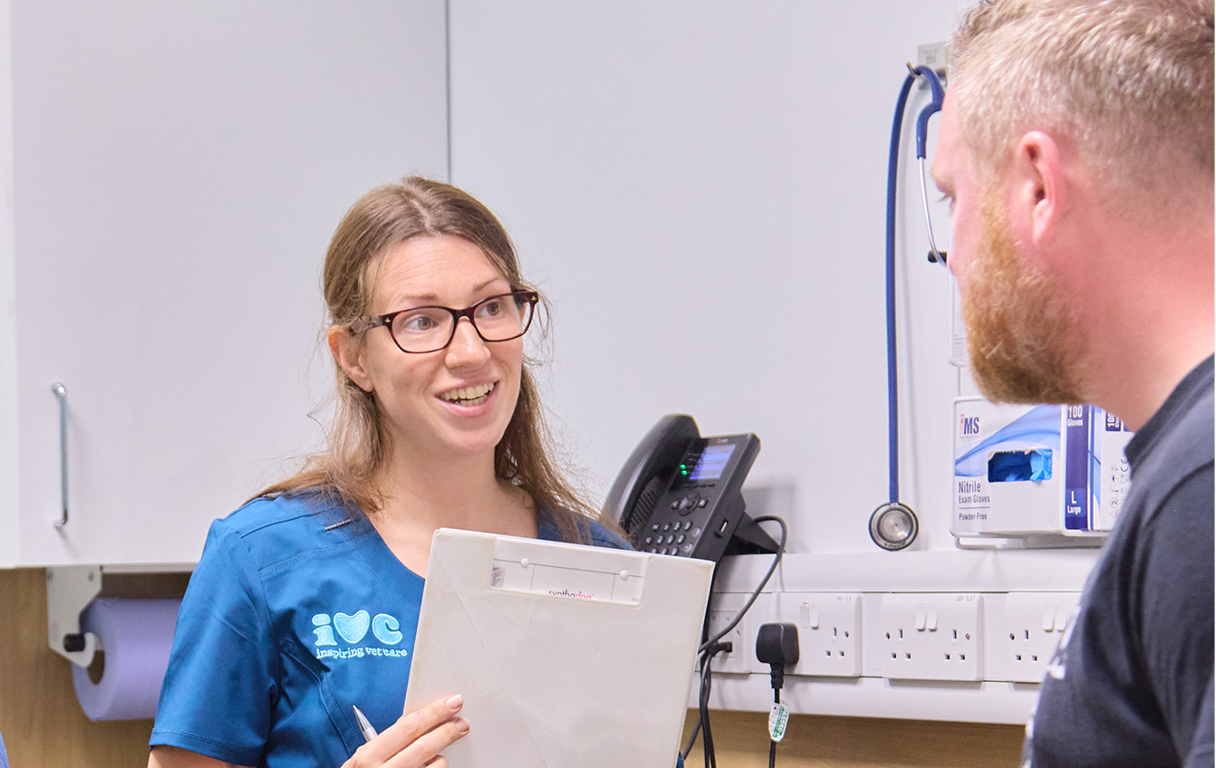 A vet talking to a pet owner