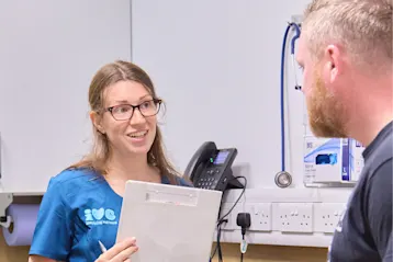 A vet talking to a pet owner