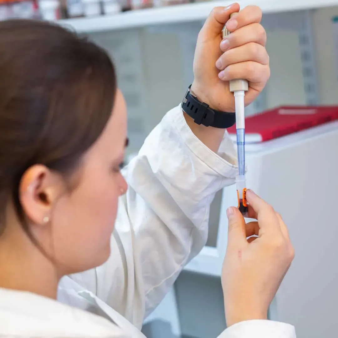 vet holding a syringe for laboratory test