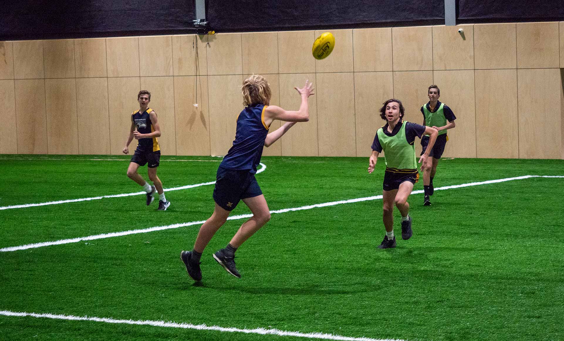 Kids playing footy at AFL Max indoor entertainment centre