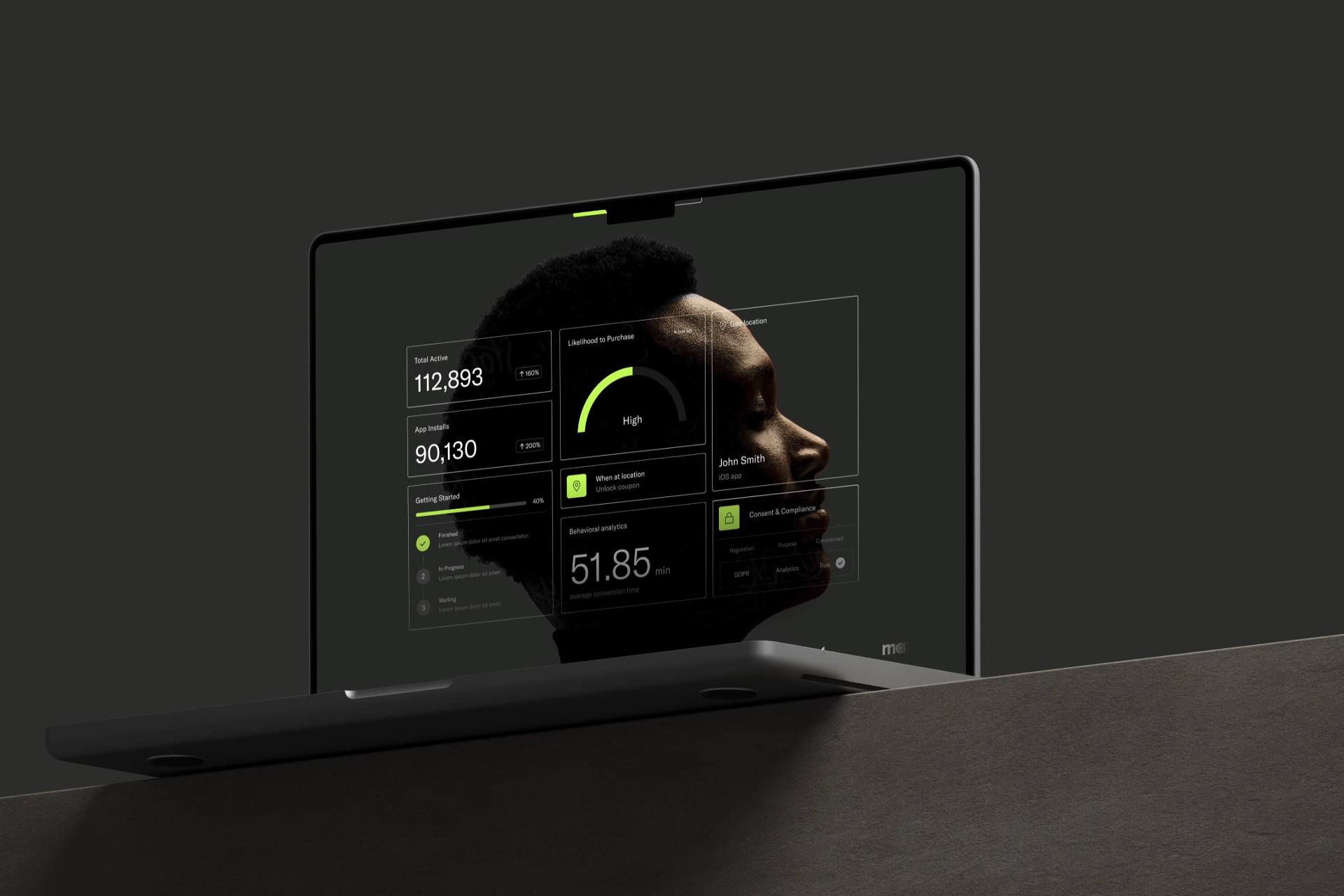 A laptop displaying futuristic data dashboards overlays the profile of a persons face on the screen, all set against a dark, minimalist background.