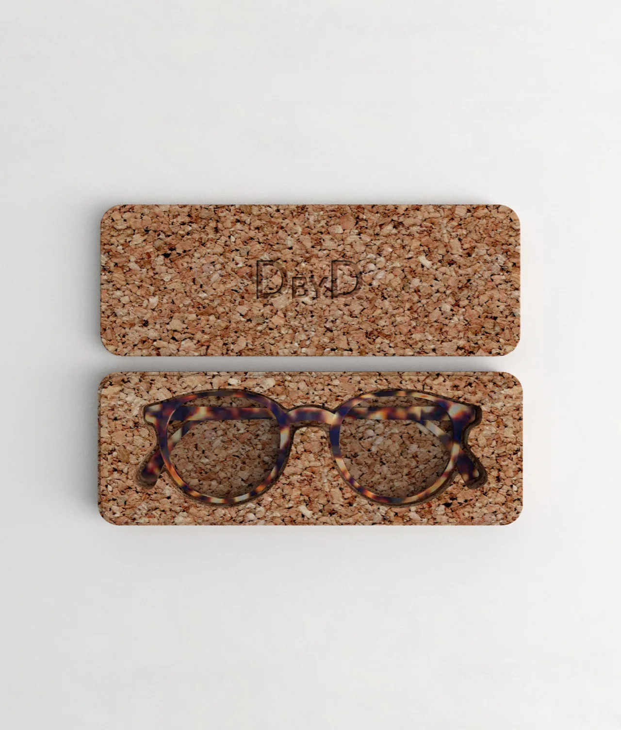 A rectangular cork eyeglasses case with the lid removed, revealing a pair of round, tortoiseshell glasses inside. The case and lid both have a speckled cork texture, displayed on a white background.
