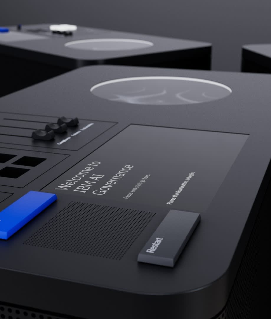 Close-up of a sleek black device with a digital display reading Welcome to IBM AI Governance. The device features several buttons, including a prominent blue one and a black one labeled Restart.