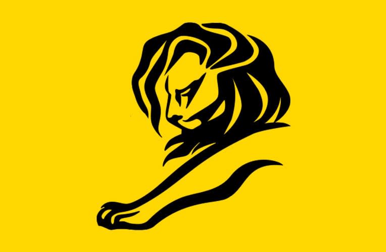 A minimalist black line drawing of a lion with a flowing mane and outstretched paw, set against a bright yellow background.