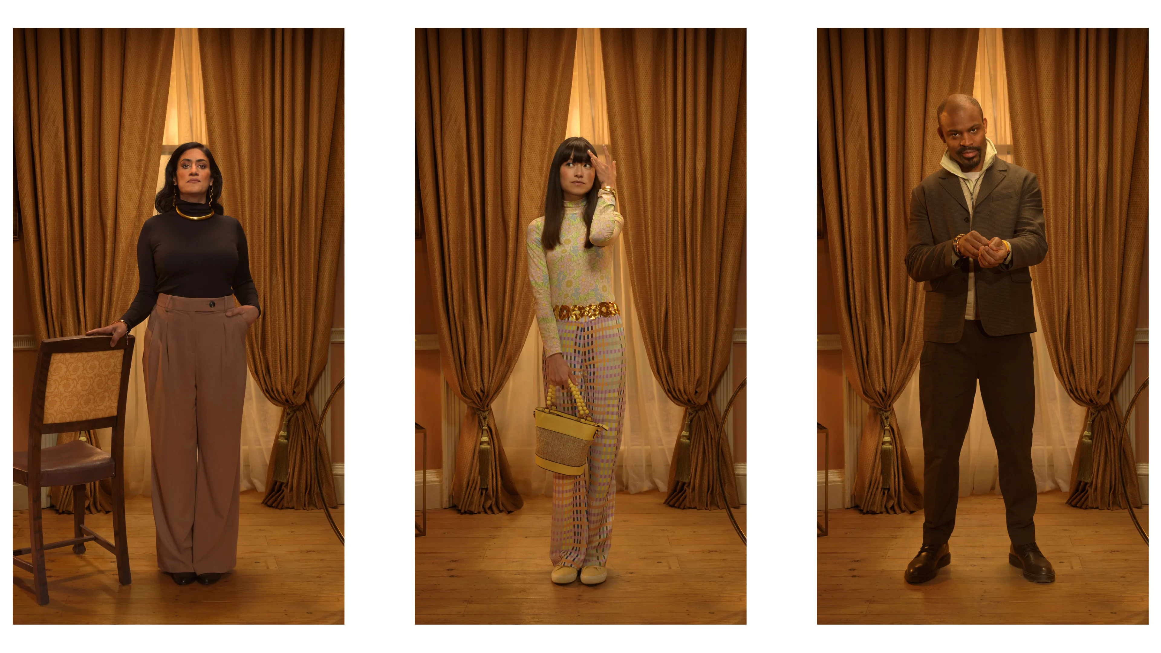 Three people stand separately indoors against brown curtains: a woman in high-waisted pants and a black top, a woman in a colorful outfit with a purse, and a man in a suit adjusting his sleeve.