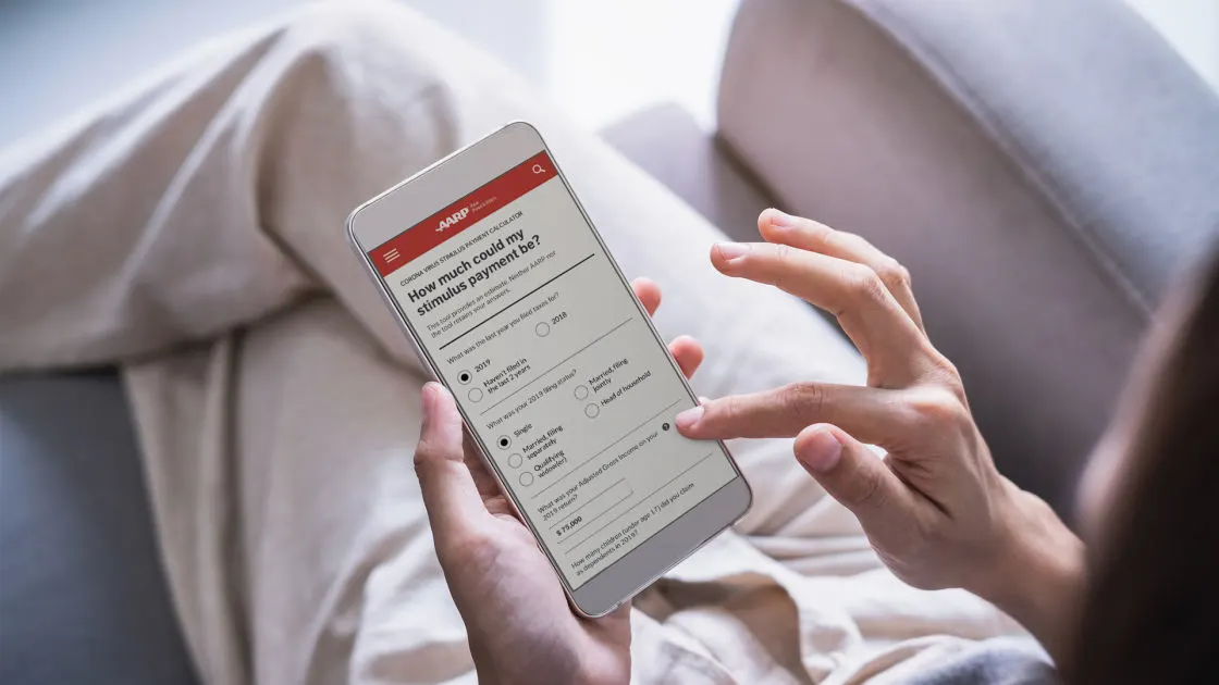 A person lounging on a sofa uses a smartphone to fill out an online survey titled How much should my stimulus pay payment be? displayed on the screen.