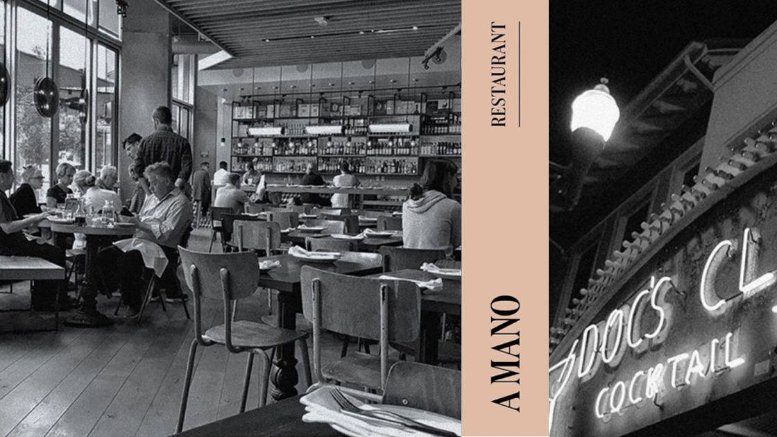 Black and white photo of a busy restaurant with diners and a server. A vertical beige banner reads RESTAURANT and A MANO. A neon sign outside spells COCKTAIL under a streetlamp.