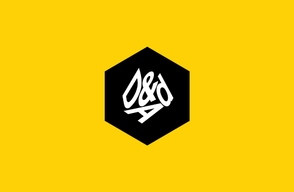 A black hexagon with white stylized “D&AD” text in the center, set against a bright yellow background.