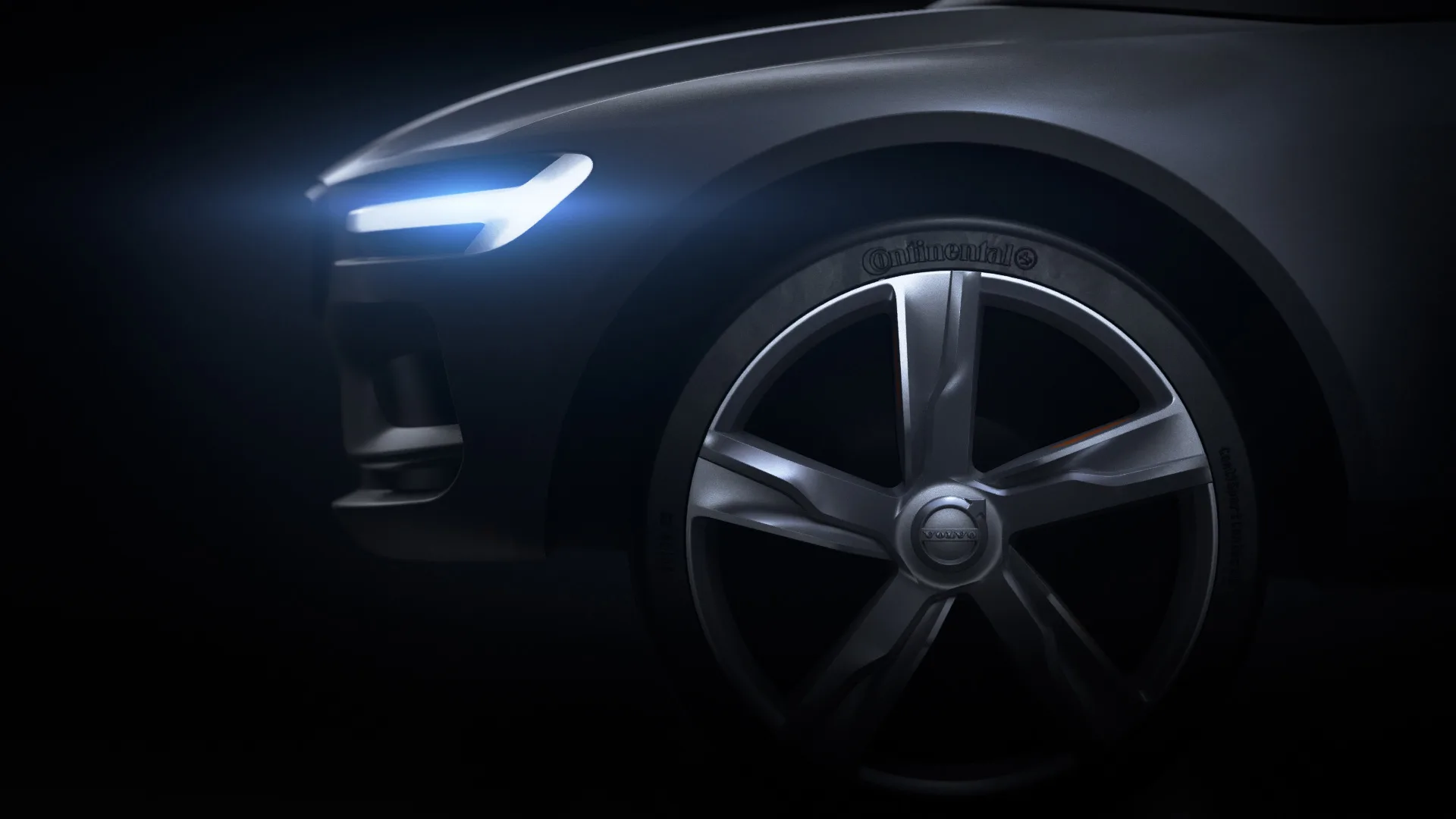 Close-up of a modern car’s front left side, featuring a sleek headlight illuminated in blue, a large alloy wheel, and the Continental tire logo, set against a dark background.
