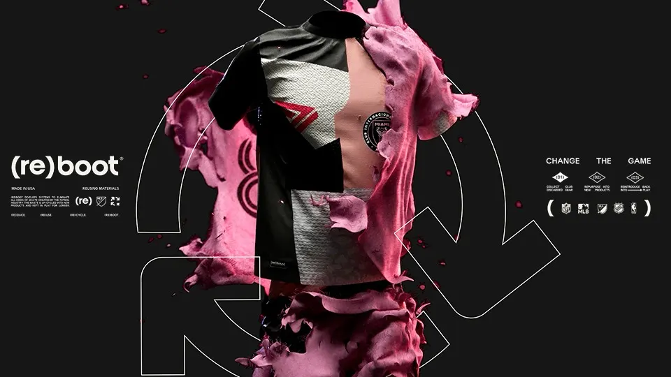 A soccer jersey, half-dissolved into pink, petal-like fragments, is displayed against a dark background with recycling-themed graphics and the word “(re)boot. Symbols for recycling and sustainability are also visible.