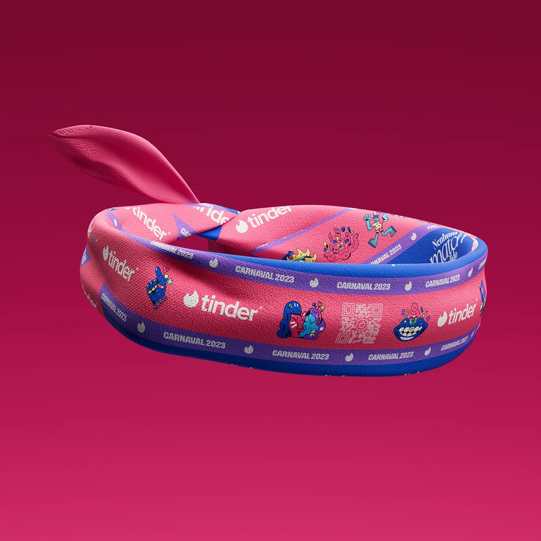 A colorful festival wristband with Tinder, CARNAVAL 2023, and various playful cartoon icons and patterns, displayed against a gradient pink background.