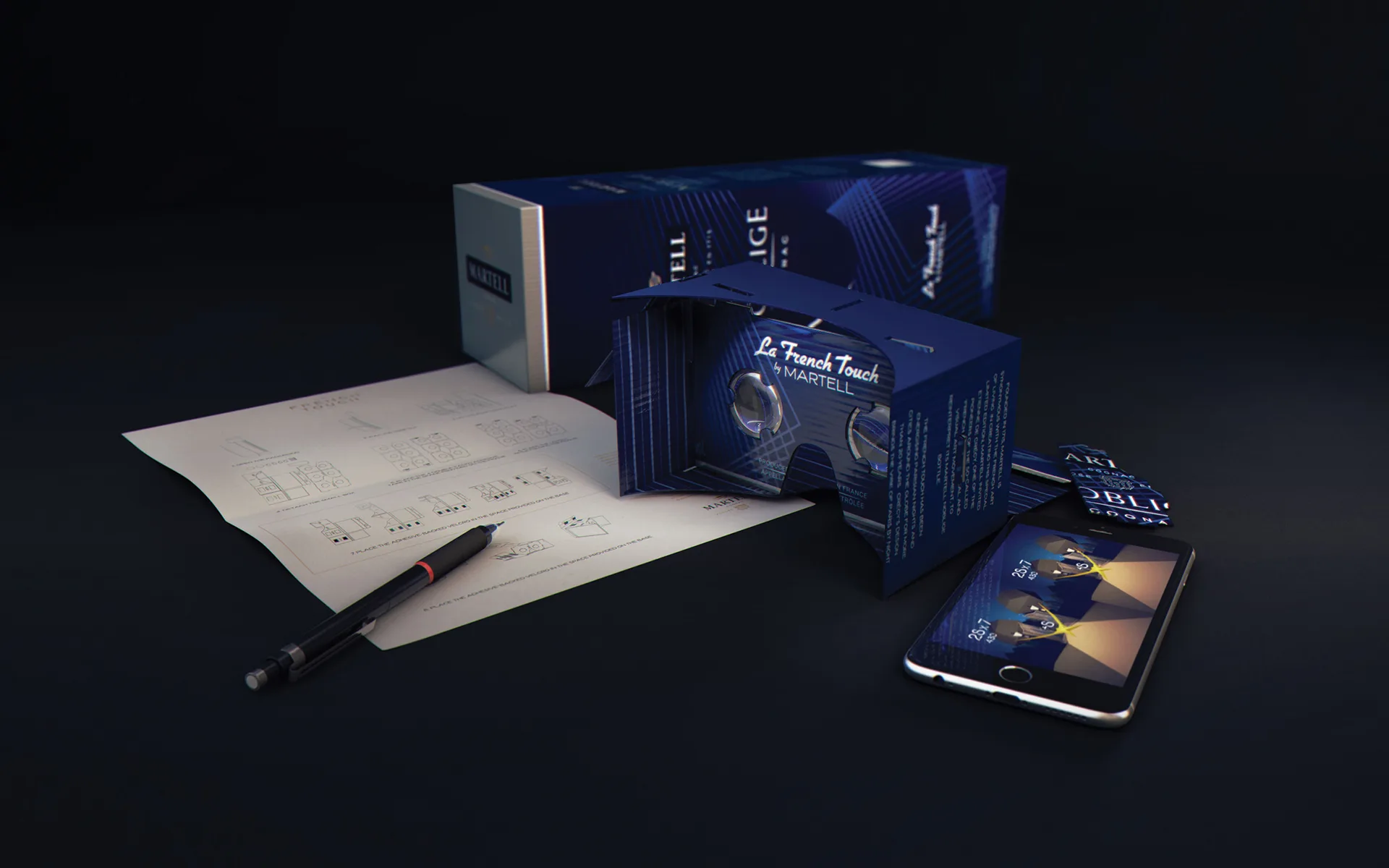 A smartphone displays a virtual reality interface beside a blue VR headset, schematic papers, a pen, a box labeled Martell, and informational leaflets, all set on a dark surface with dramatic lighting.