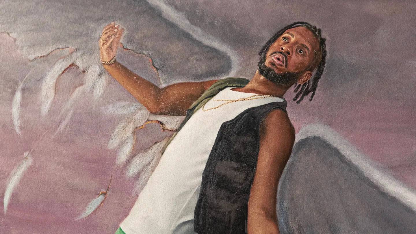 A man with dreadlocks, wearing a white shirt and dark vest, leans backward with a surprised expression as large, grey angel wings with tattered feathers extend from his back against a purple sky.