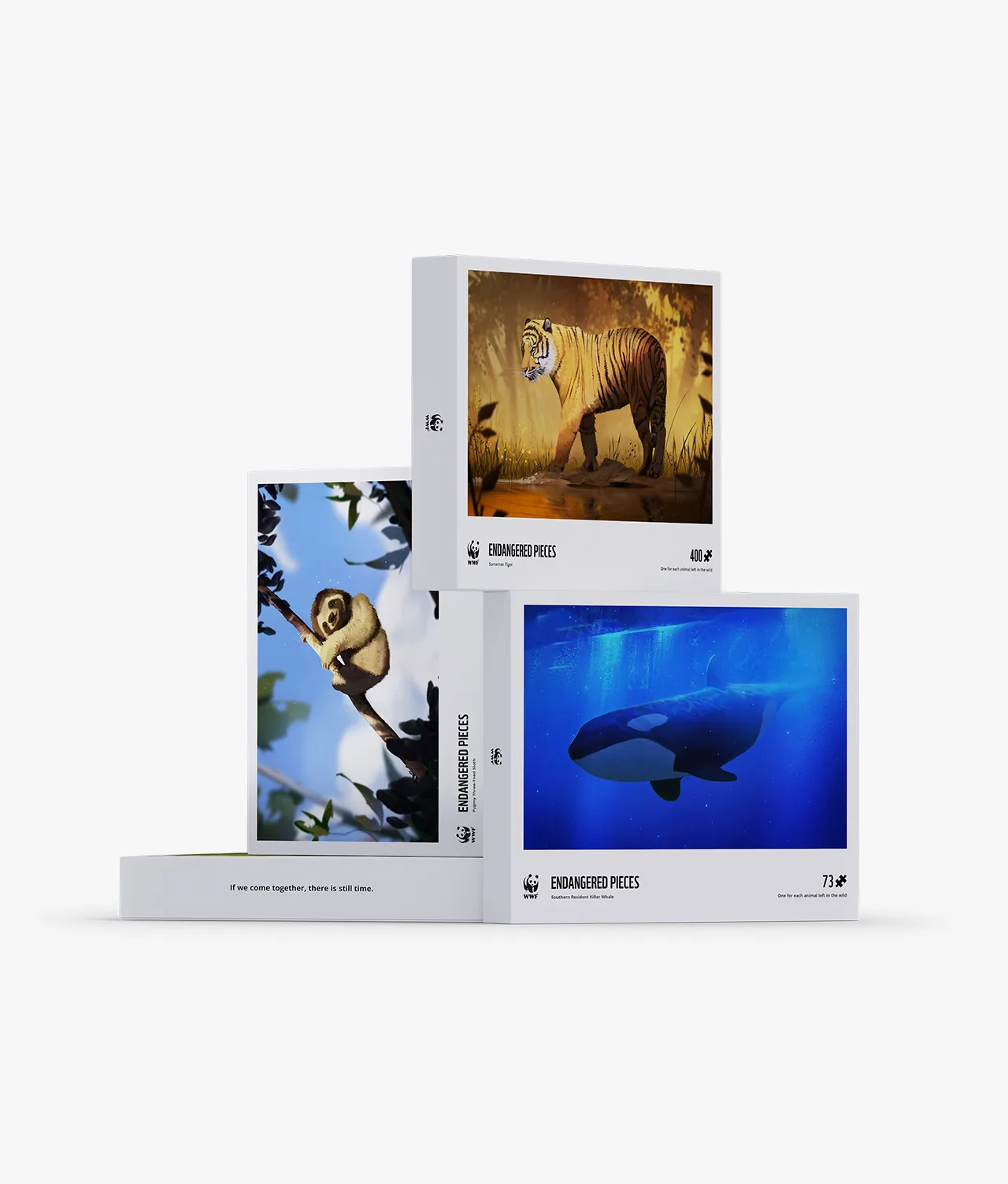 Three puzzle boxes featuring endangered animals: a tiger walking in a forest, a gibbon hanging from a tree branch, and an orca swimming underwater. The boxes are stacked in a stepped arrangement.