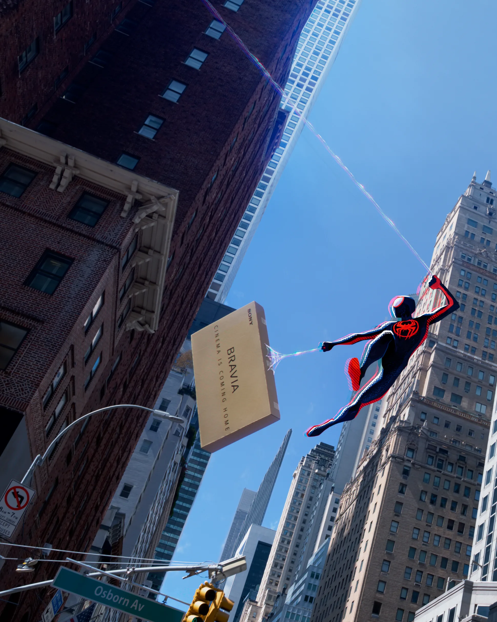 A Spider-Man character swings through a cityscape, using webs to carry a large box labeled BRAVIA among tall buildings, with traffic lights and a street sign for Osborn Ave visible below.