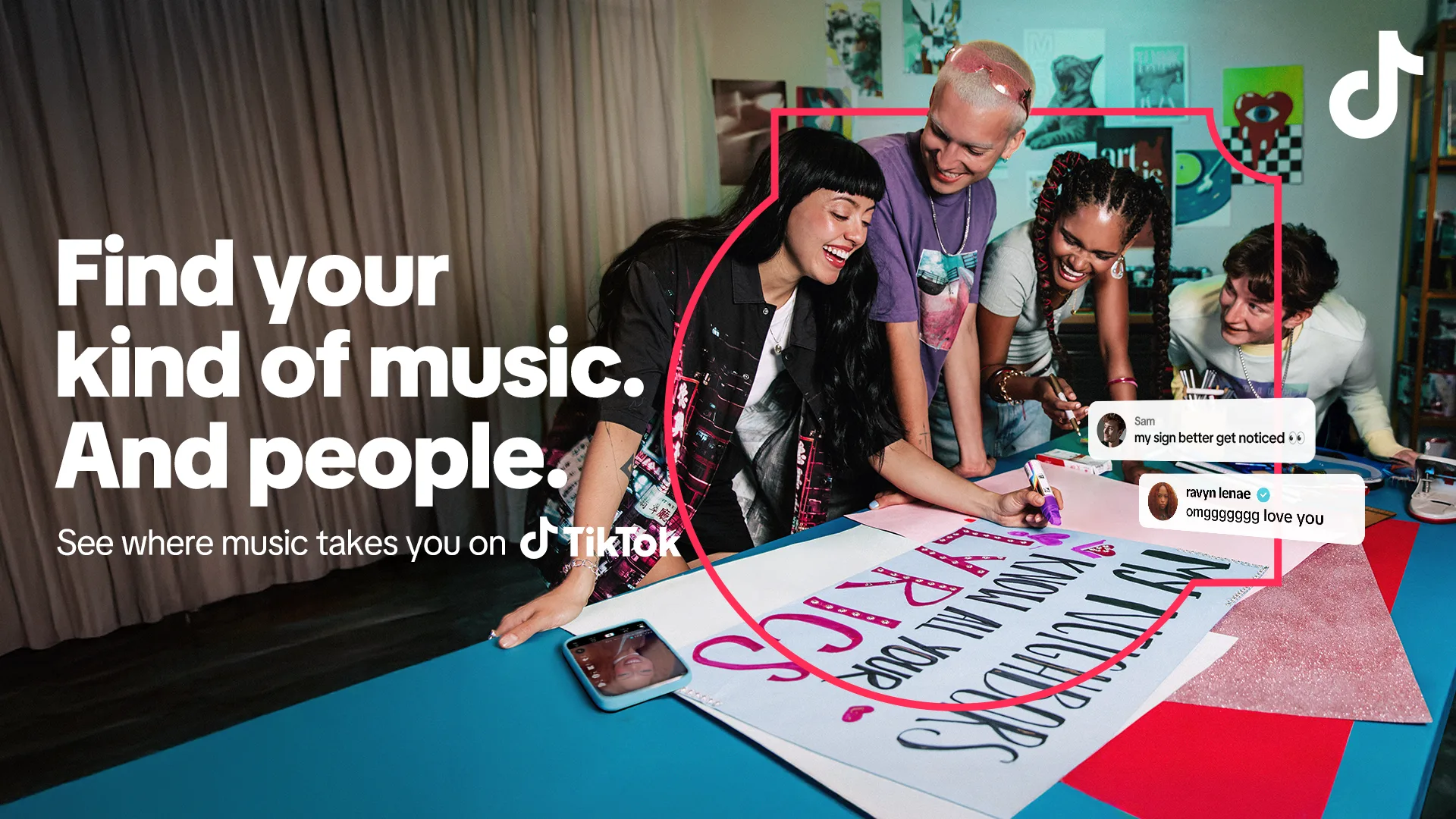Three smiling friends lean over a table, enthusiastically decorating a large poster that reads MUSIC WILL LIFT US UP, surrounded by art supplies. TikTok branding and positive social media comments are visible.