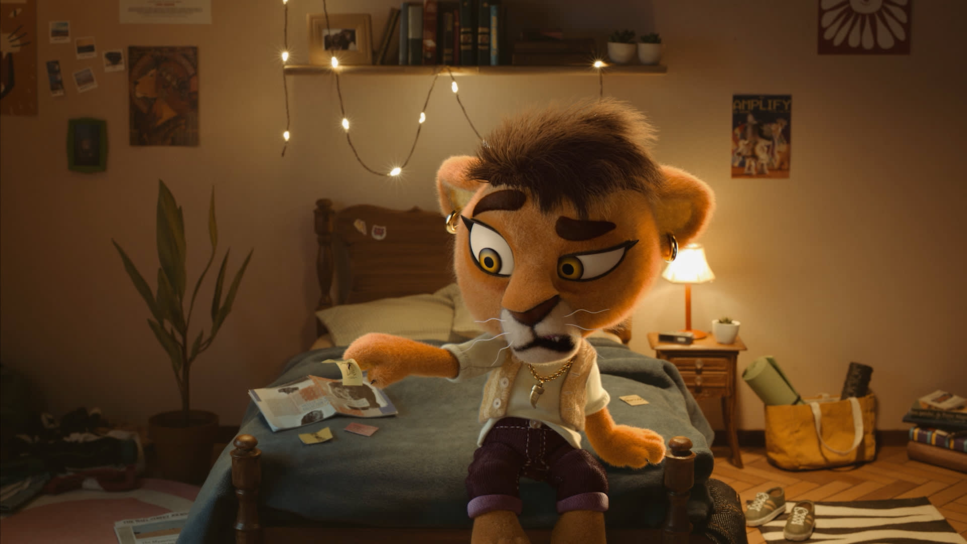 A plush lion character sits on a bed in a cozy, dimly lit room, looking worriedly at a piece of paper. The room has string lights, a plant, scattered papers, books, a backpack, and posters on the walls.