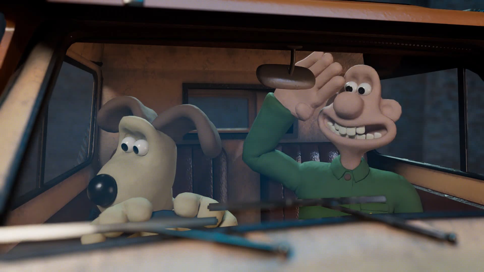 A clay animation man in a green shirt smiles and salutes while driving a car, with a concerned-looking dog sitting beside him in the passenger seat.