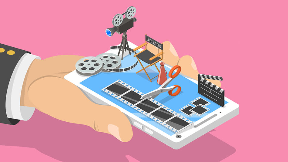 A hand holds a smartphone displaying film editing tools, including film reels, a movie camera, a directors chair, scissors, and a clapperboard, against a pink background.