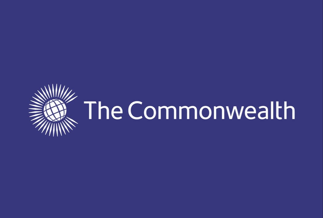 The Commonwealth logo with a globe surrounded by radiating lines on the left and the words The Commonwealth in white text on a purple background.