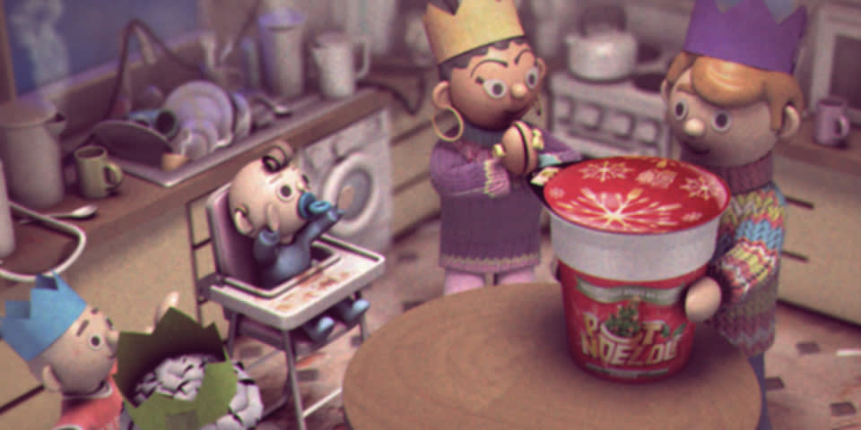 A cartoon family in party hats gathers in a messy kitchen. One adult opens a festive Pot Noodle tub at the table, while a baby eats in a highchair and another child sleeps with a party hat on. Dirty dishes are piled in the background.