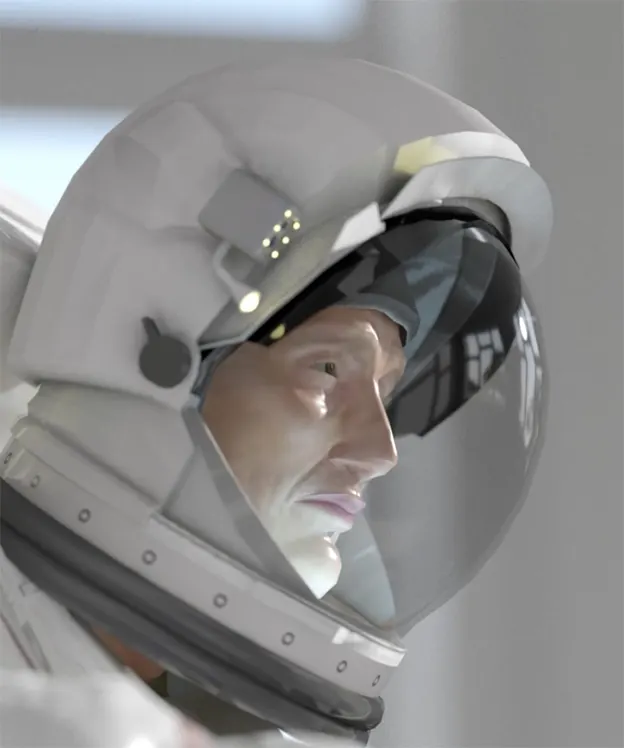 A close-up of an astronaut’s face inside a clear helmet, with a reflective visor and white space suit, looking forward in a brightly lit environment.