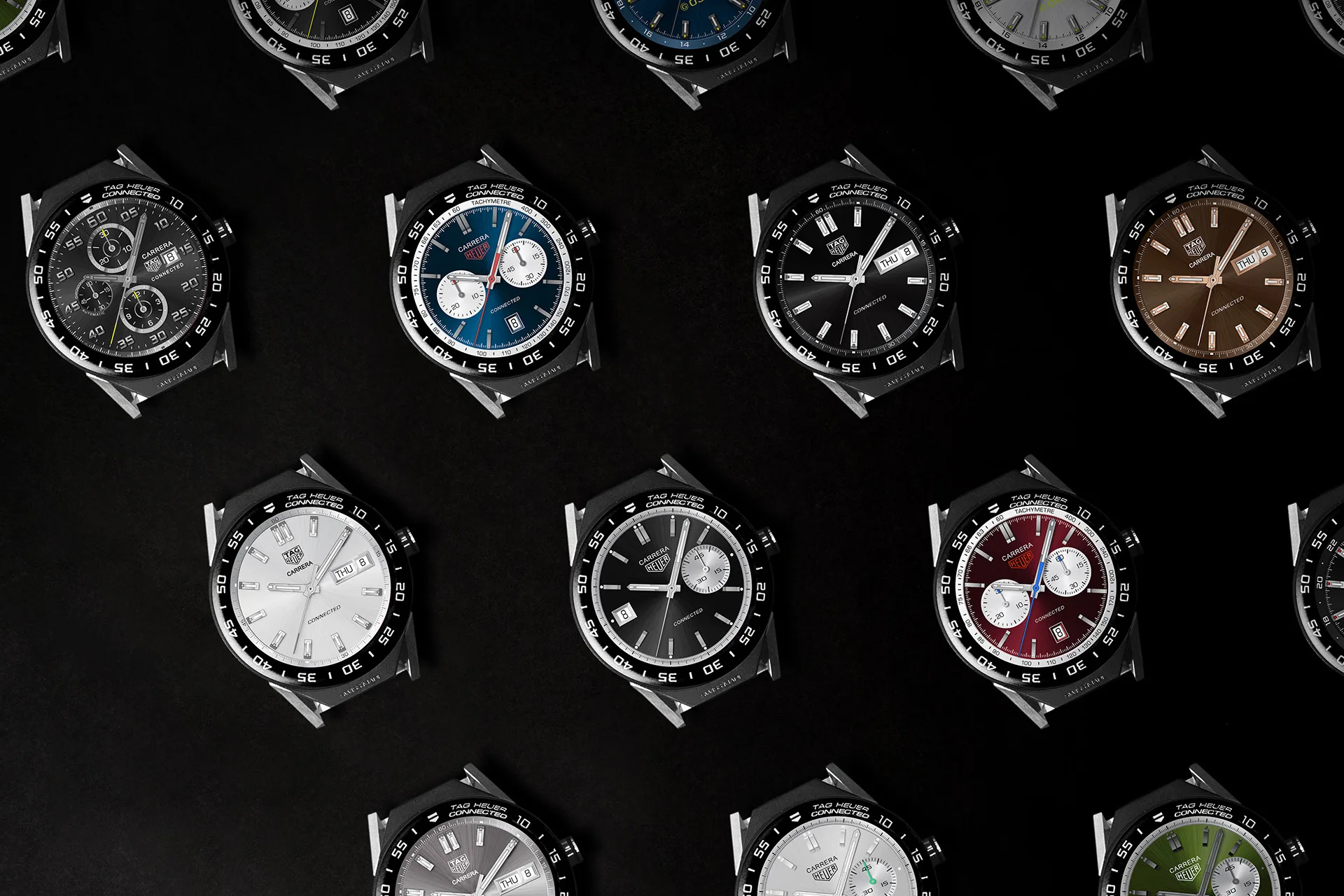 Multiple wristwatches with various dial colors and designs are arranged in a grid pattern on a black background, showcasing different styles and chronograph features.