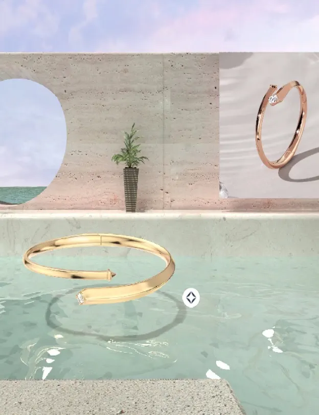 A gold, nail-shaped bracelet with a diamond tip floats above turquoise water, with a modern stone wall, a potted plant, and an ocean view in the background. Another bracelet is displayed on the wall.